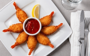 Breaded shrimp deep fried, with cocktail sauce