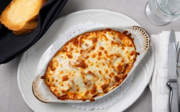 baked lasagna layered with meat sauce and topped with a blend of Monterey Jack, Parmesan & Mozza