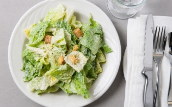 Romaine lettuce with our own Caesar dressing topped with Parmesan cheese and croutons